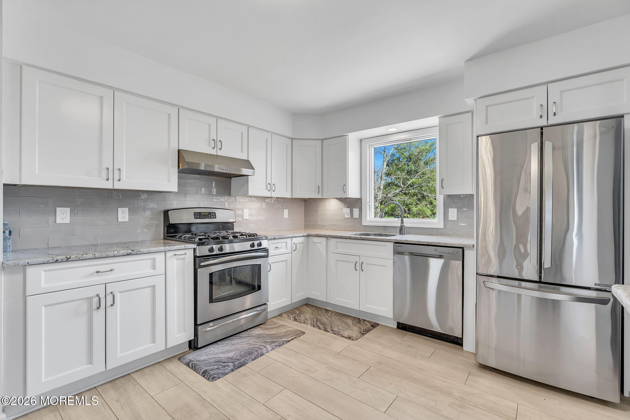 50 Virginia Drive Howell, NJ 07731 - Photo 3 of 33 a kitchen with cabinets stainless steel appliances and window