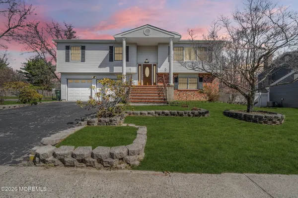 a front view of a house with a garden