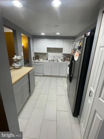 a kitchen with a sink a stove cabinets and a counter top space