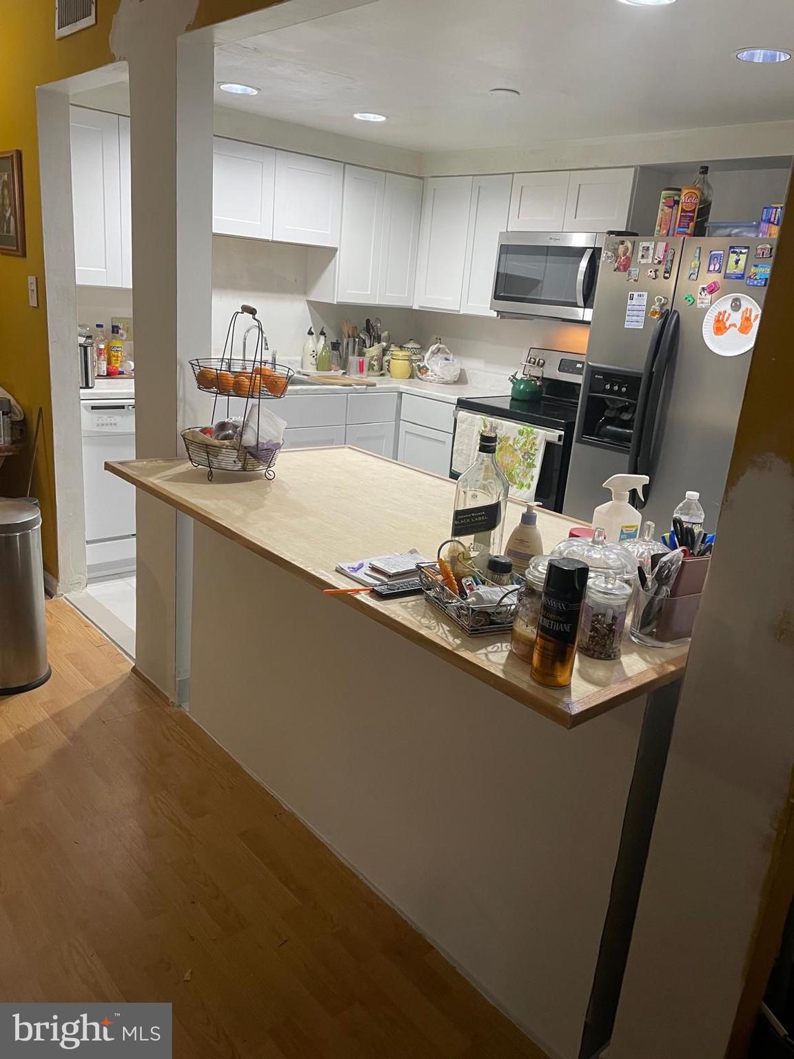 8434 Towne Crest Court Gaithersburg, MD 20877 - Photo 4 of 8 a kitchen with kitchen island granite countertop a sink stove and refrigerator