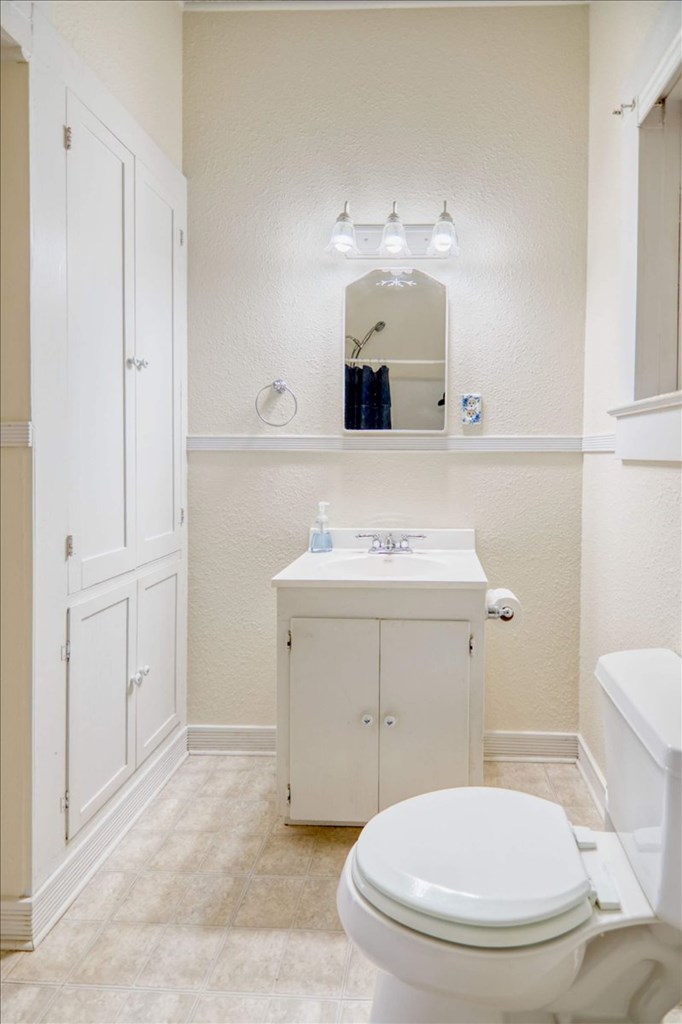205 East Rainey Street Mason, TX 76856 - Photo 17 of 37 a bathroom with a sink toilet and mirror