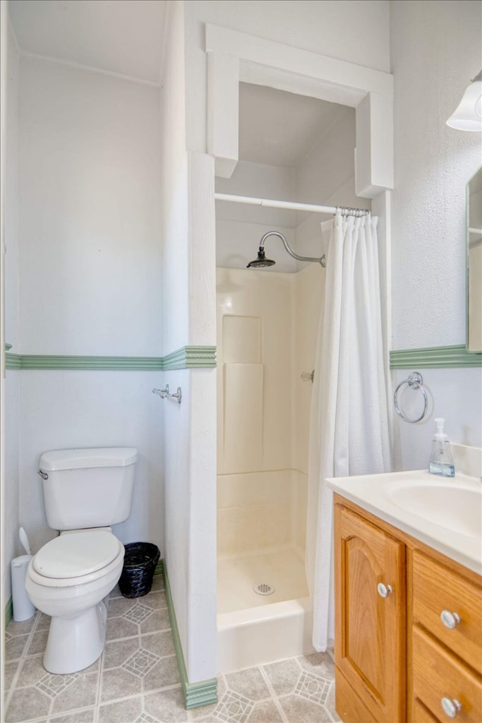 205 East Rainey Street Mason, TX 76856 - Photo 19 of 37 a bathroom with a granite countertop sink toilet and shower