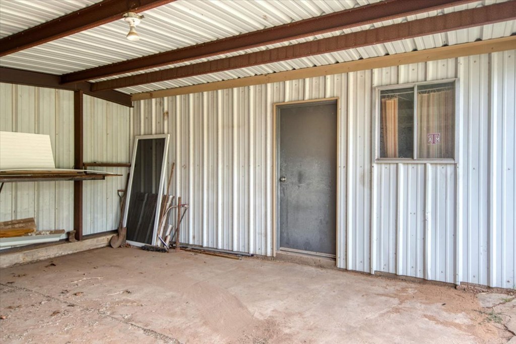 205 East Rainey Street Mason, TX 76856 - Photo 23 of 37 an empty room with wooden floor and a ceiling fan