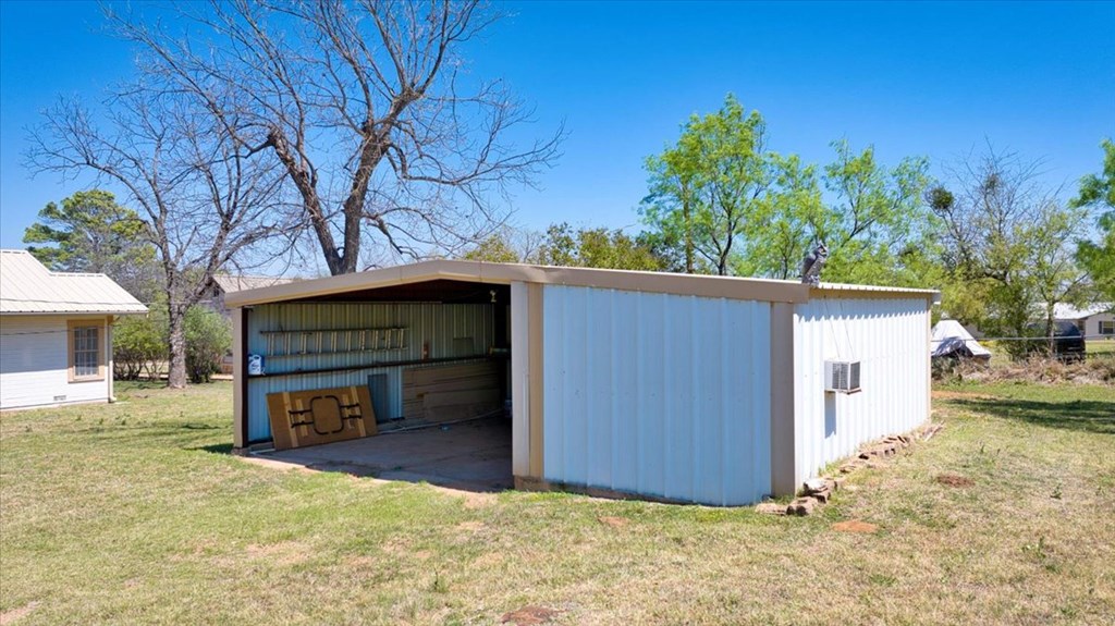 205 East Rainey Street Mason, TX 76856 - Photo 33 of 37 a view of a house with a yard and garage