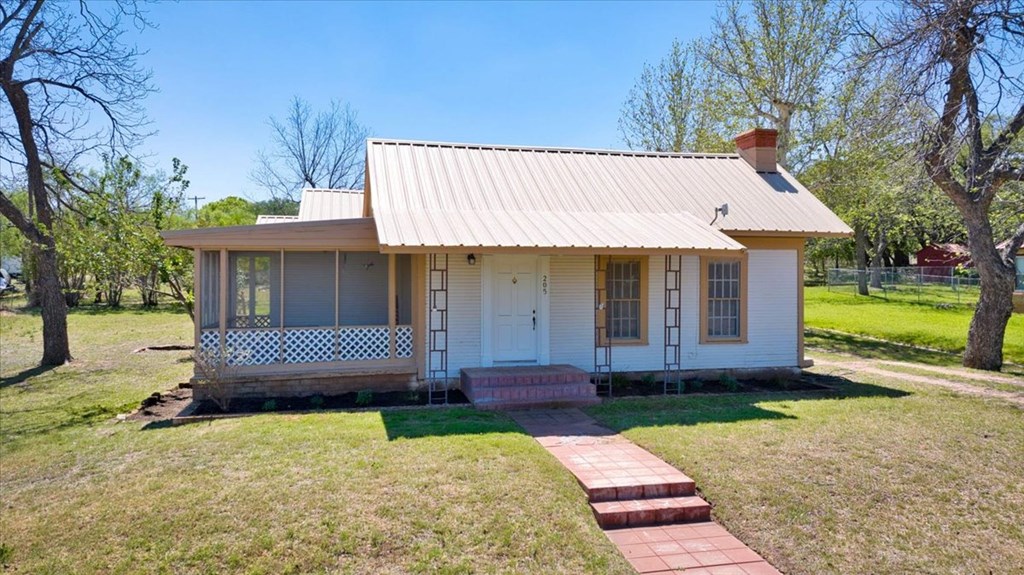 205 East Rainey Street Mason, TX 76856 - Photo 35 of 37 a front view of a house with a garden and yard
