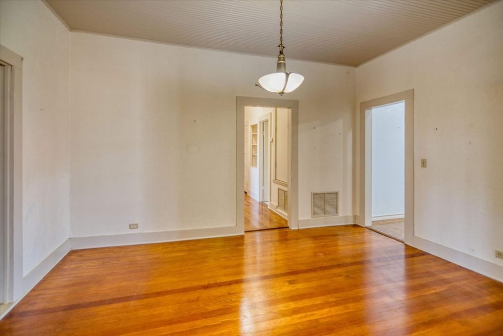 205 East Rainey Street Mason, TX 76856 - Photo 4 of 37 a view of an empty room with wooden floor and a window
