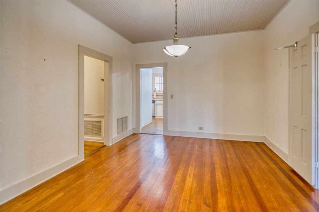 205 East Rainey Street Mason, TX 76856 - Photo 6 of 37 a view of an empty room with wooden floor and a window