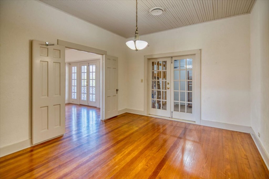205 East Rainey Street Mason, TX 76856 - Photo 7 of 37 a view of an empty room with wooden floor and a window