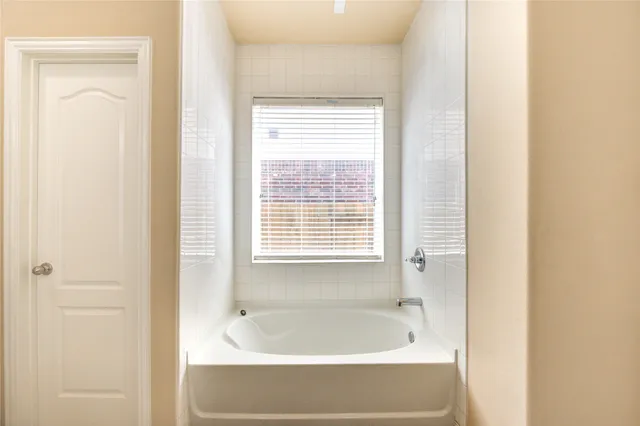 a bath tub sitting next to a window
