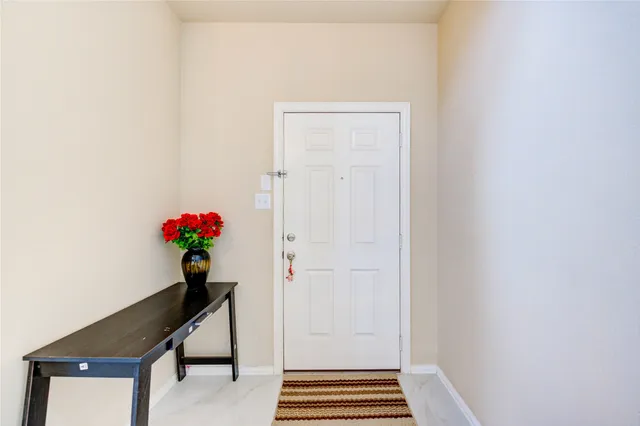a hallway with flowers and a potted plant