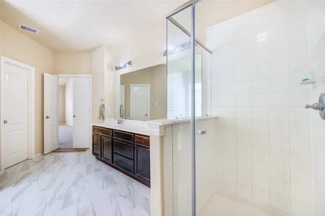 a large bathroom with a sink and a mirror