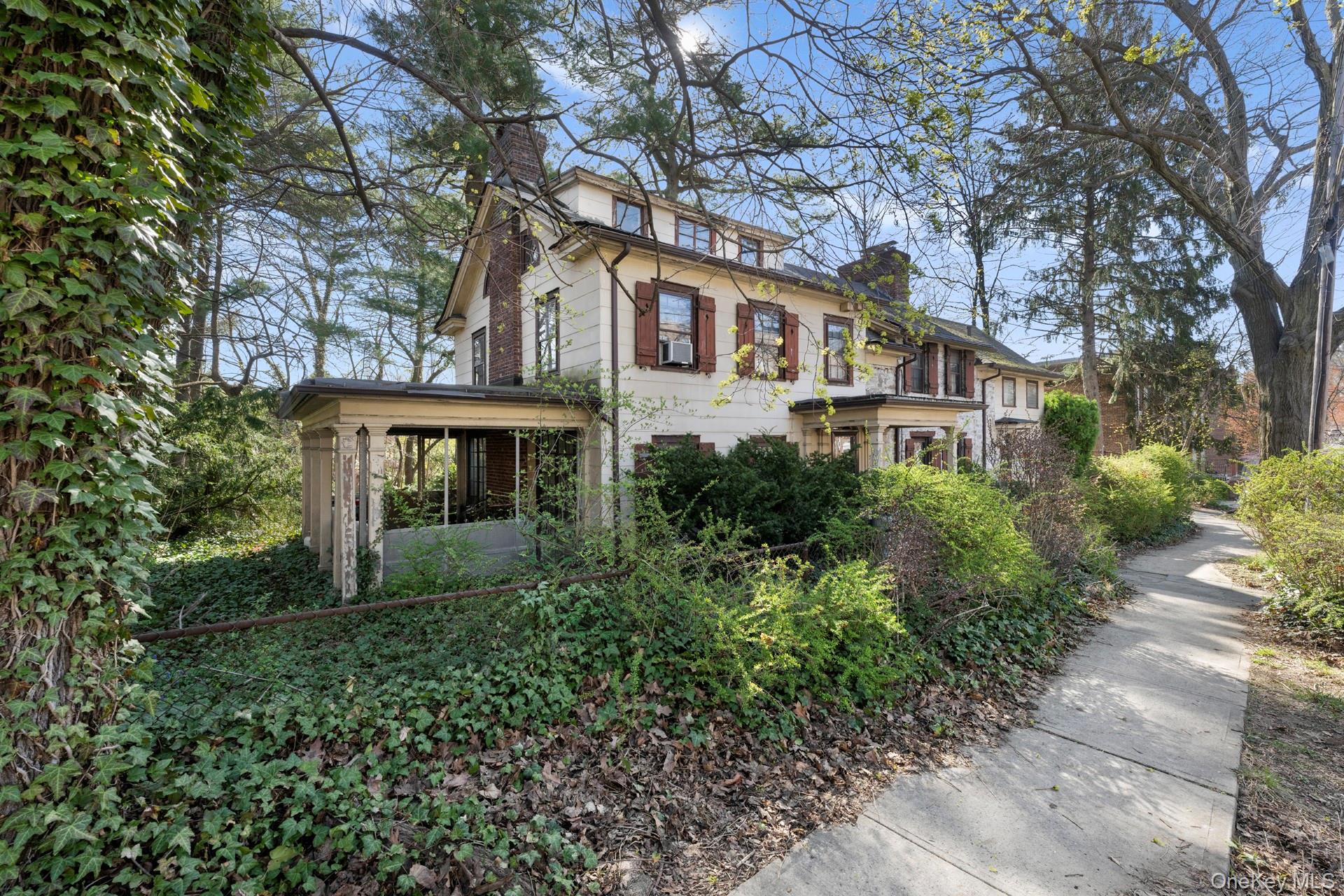 5122 Post Road Bronx, NY 10471 - Photo 2 of 11 a front view of a house with plants and trees