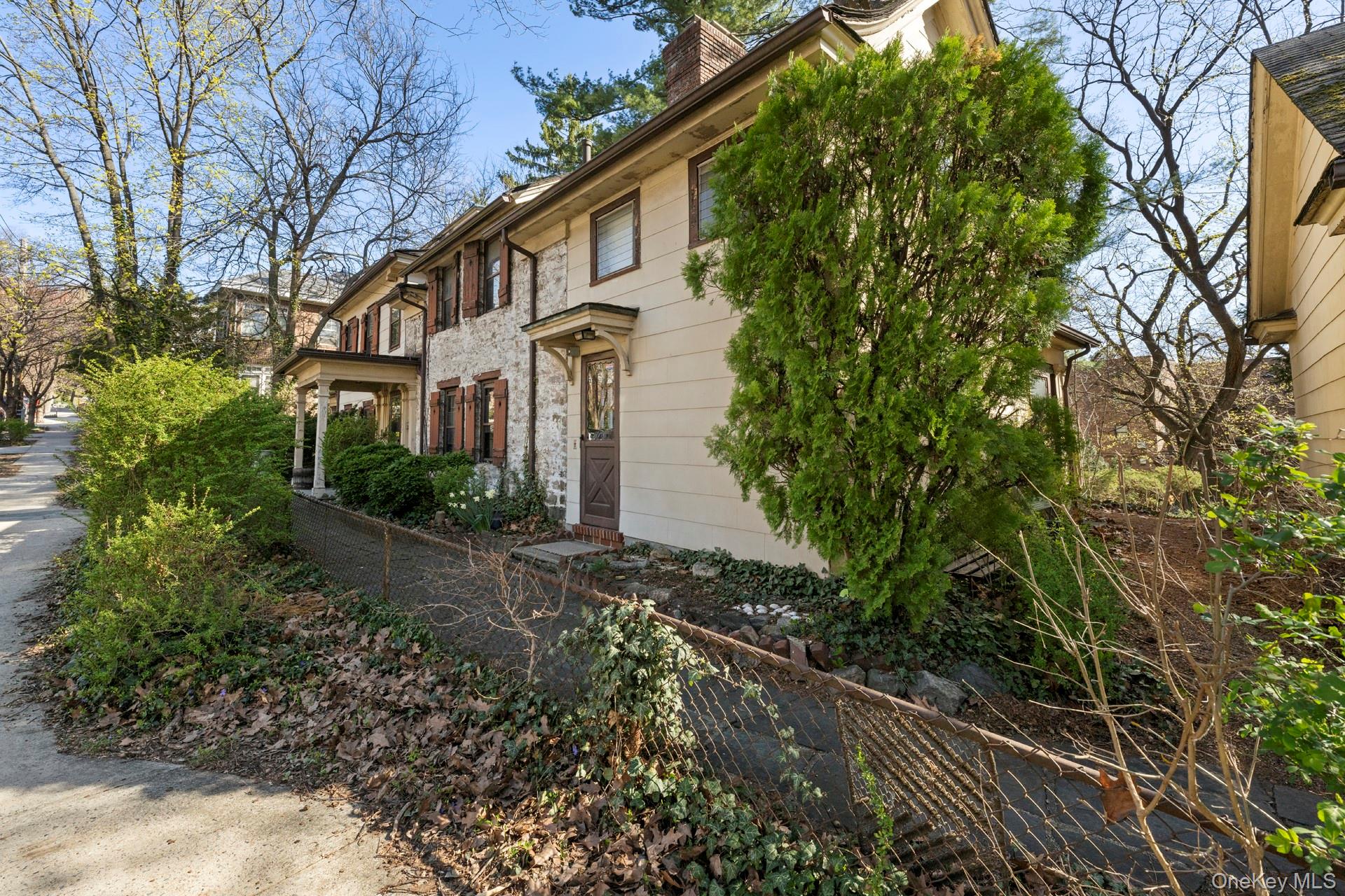 5122 Post Road Bronx, NY 10471 - Photo 6 of 11 a view of a white house with a yard and plants