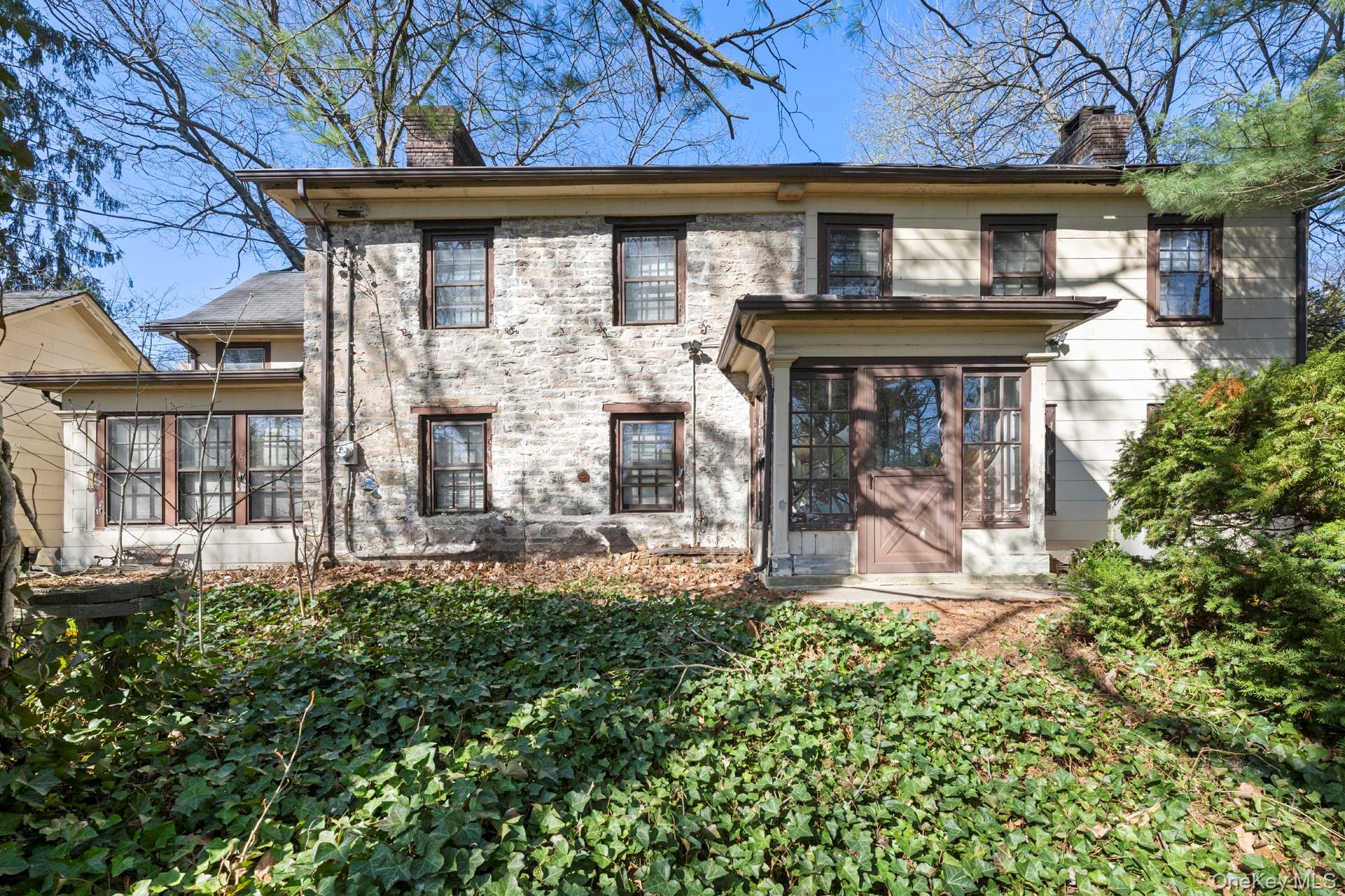 5122 Post Road Bronx, NY 10471 - Photo 8 of 11 a front view of a house with garden