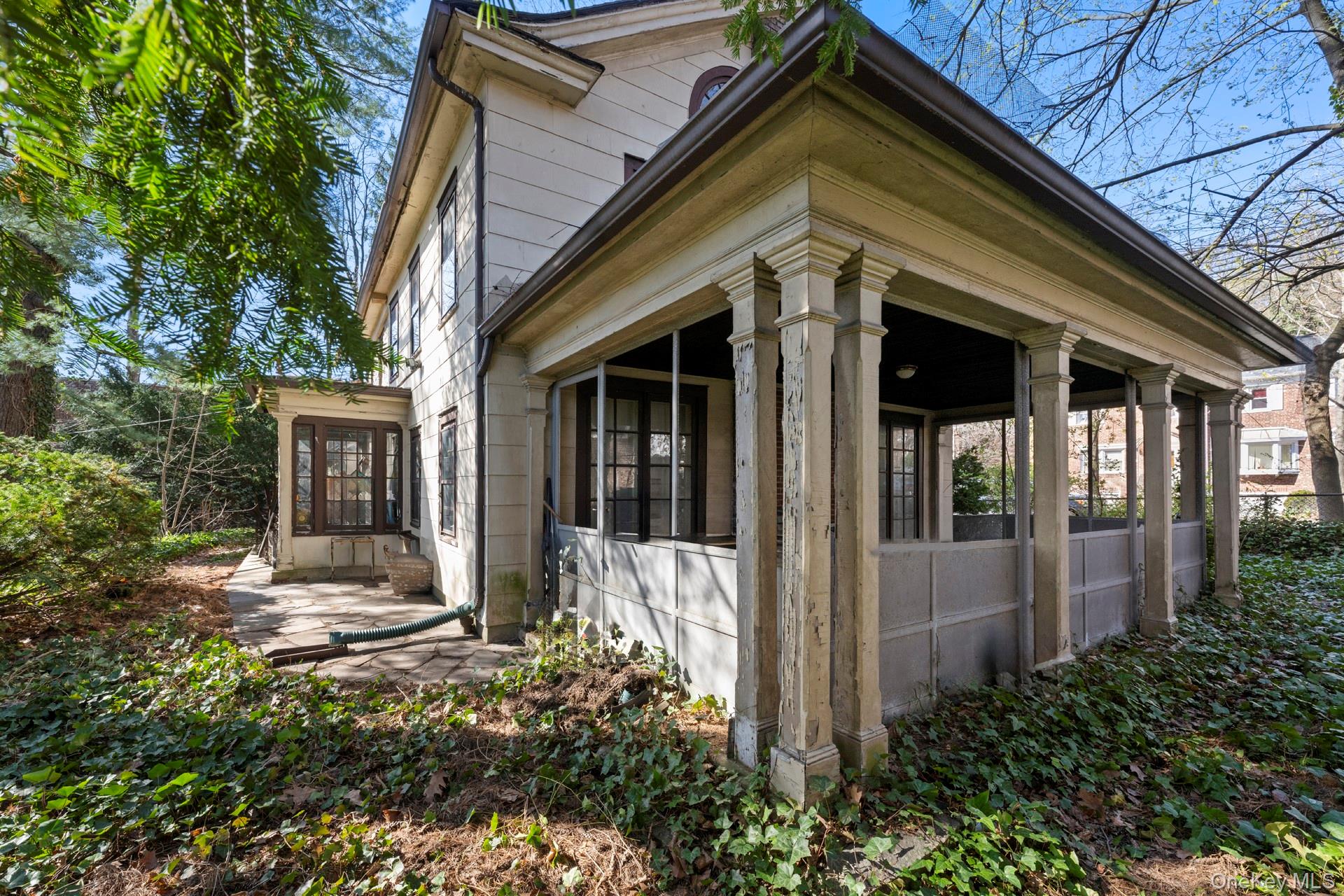 5122 Post Road Bronx, NY 10471 - Photo 9 of 11 a view of a house with small yard plants and large tree