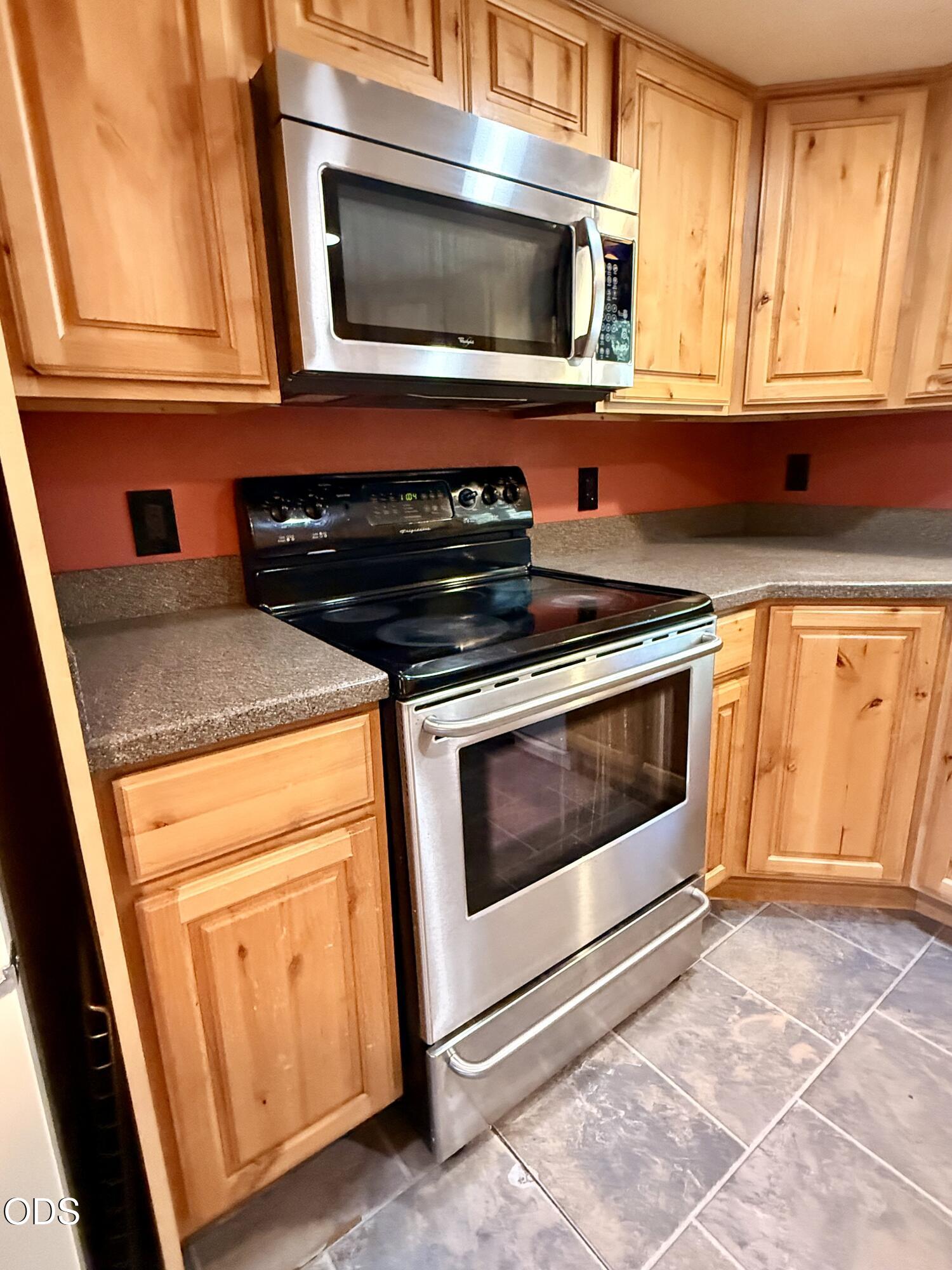 16025 Strawn Road La Pine, OR 97739 - Photo 22 of 95 a kitchen with stainless steel appliances granite countertop a stove microwave and sink