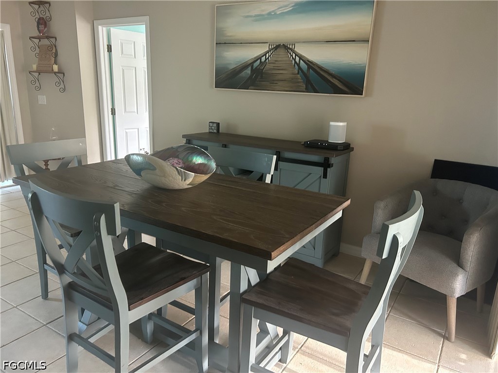 12341 Marlin Road Bokeelia, FL 33922 - Photo 11 of 26 a view of a dining room with furniture and window
