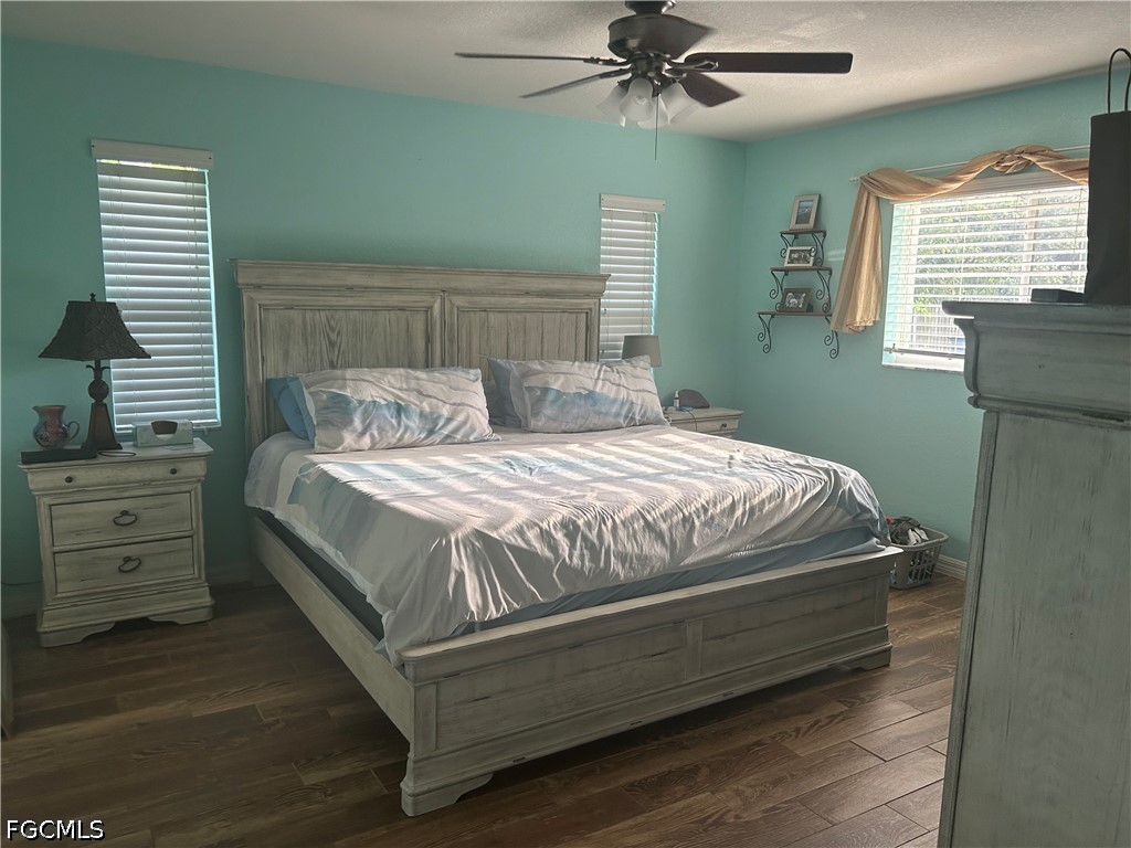 12341 Marlin Road Bokeelia, FL 33922 - Photo 15 of 26 a bedroom with a bed and a chandelier
