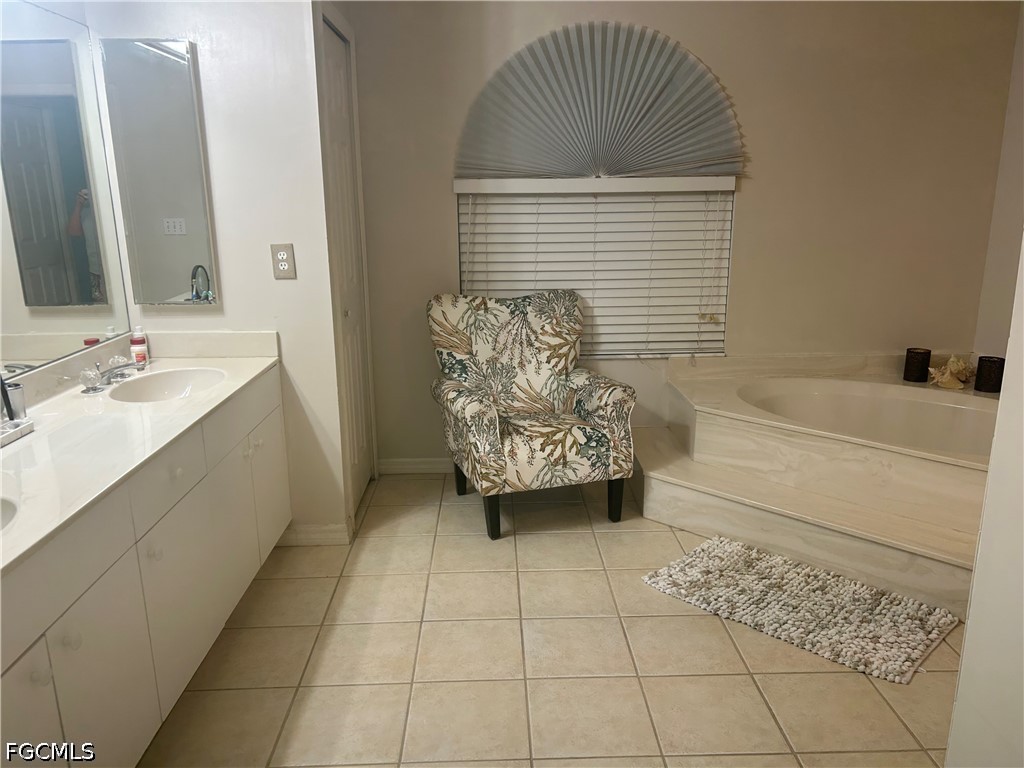 12341 Marlin Road Bokeelia, FL 33922 - Photo 17 of 26 a bathroom with a bathtub sink and mirror