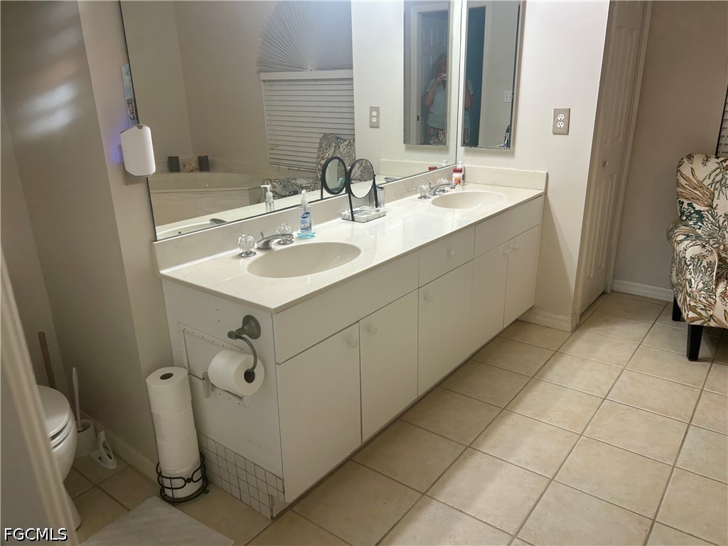 12341 Marlin Road Bokeelia, FL 33922 - Photo 18 of 26 a bathroom with a sink toilet and mirror
