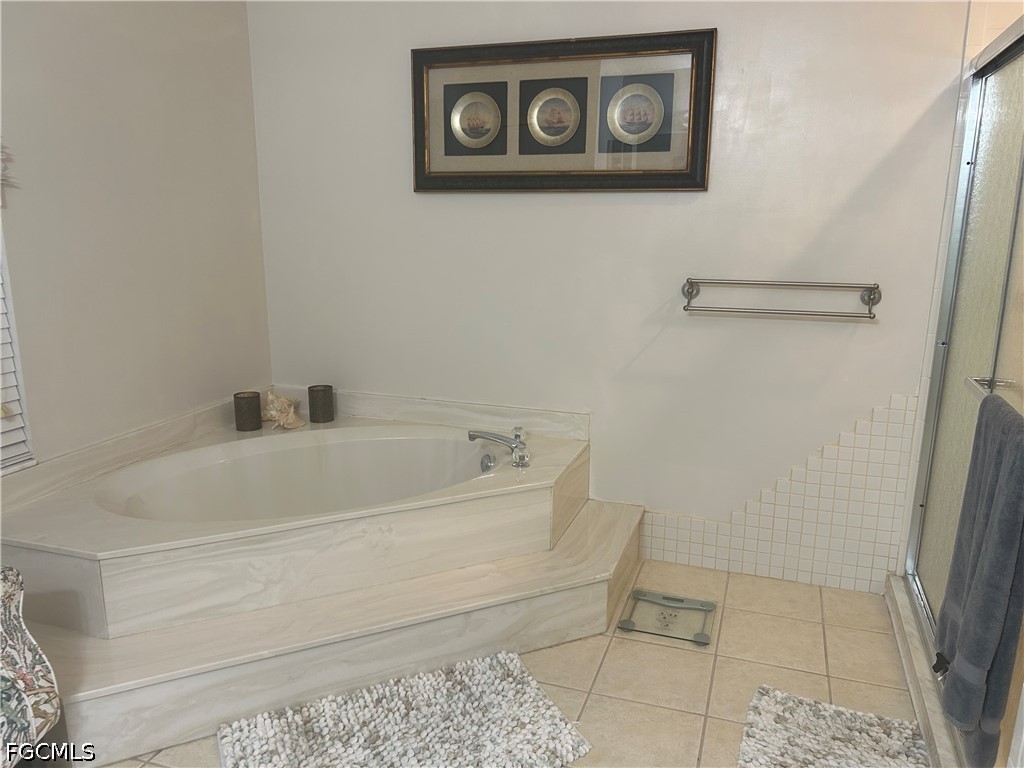 12341 Marlin Road Bokeelia, FL 33922 - Photo 20 of 26 a white bath tub sitting next to a white toilet