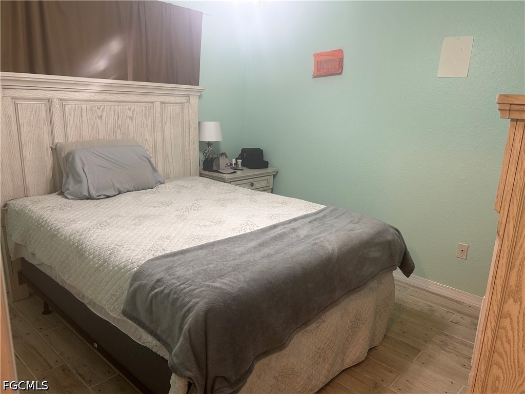 12341 Marlin Road Bokeelia, FL 33922 - Photo 21 of 26 a large bed sitting in a bedroom next to a window