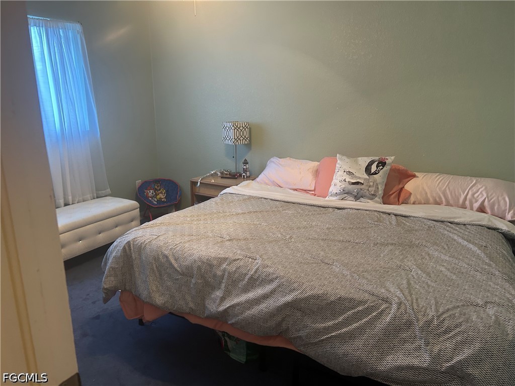 12341 Marlin Road Bokeelia, FL 33922 - Photo 23 of 26 a bedroom with a bed and a window