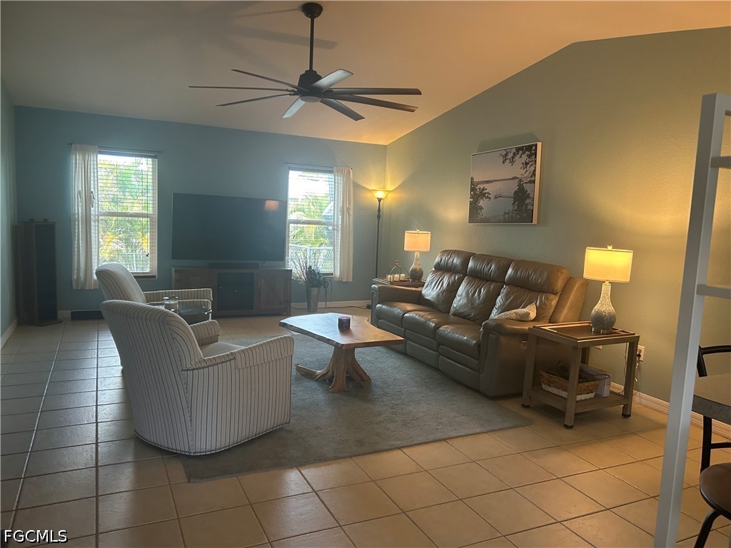 12341 Marlin Road Bokeelia, FL 33922 - Photo 5 of 26 a living room with furniture and a chandelier