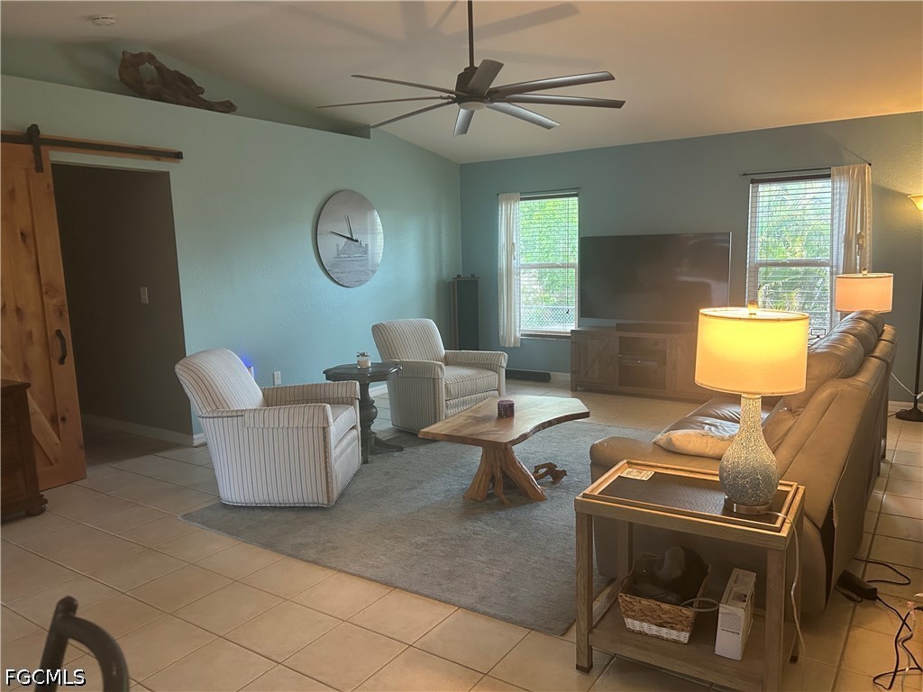 12341 Marlin Road Bokeelia, FL 33922 - Photo 6 of 26 a living room with furniture a window and a flat screen tv
