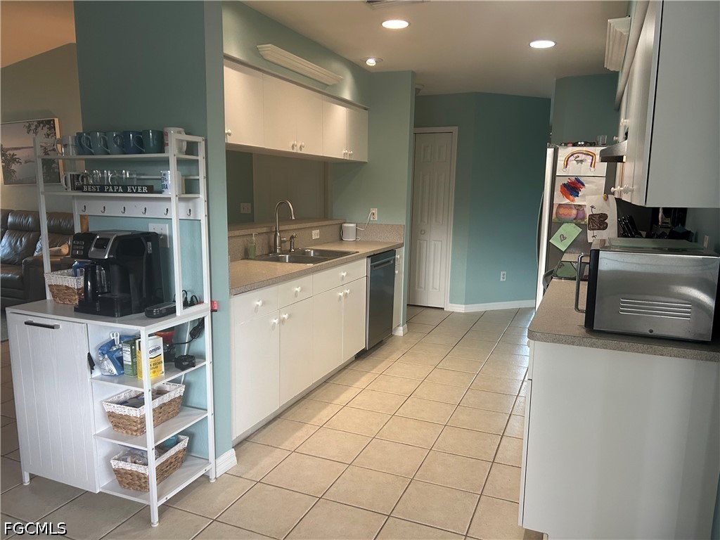 12341 Marlin Road Bokeelia, FL 33922 - Photo 8 of 26 a kitchen with stainless steel appliances a sink and a refrigerator