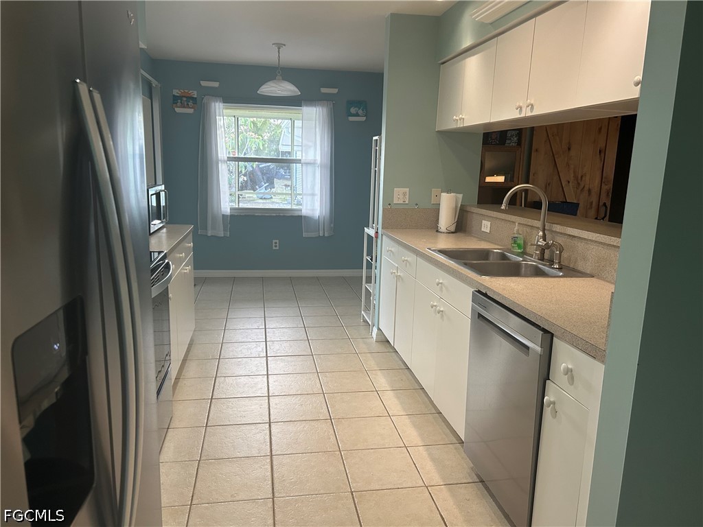 12341 Marlin Road Bokeelia, FL 33922 - Photo 9 of 26 a bathroom with a sink a toilet a mirror and window