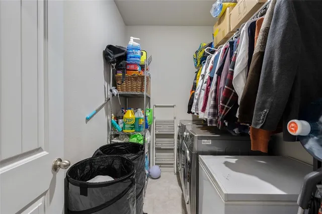 a view of walk in closet with clothes and shoes