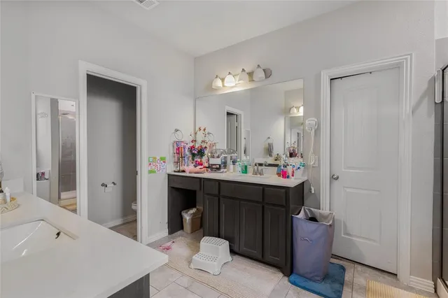 a bathroom with a sink vanity and a mirror