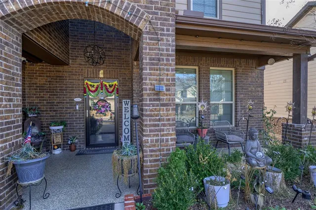 a brick building with a potted plant on the wall
