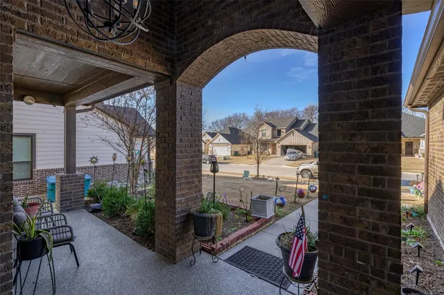 a view of a porch with furniture and floor to ceiling window