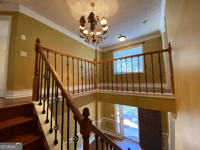 a view of a porch with wooden floor and furniture