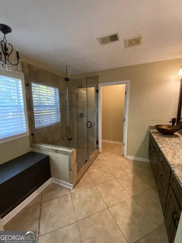 a spacious bathroom with a sink and a large mirror