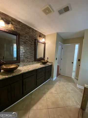 a bathroom with a shower and a sink