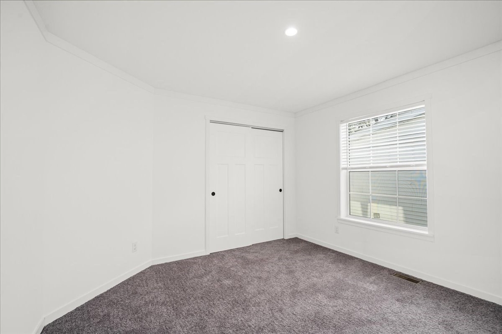 6 Berry Farms Road, Unit 64 Sturbridge, MA 01566 - Photo 15 of 18 a view of an empty room with a window