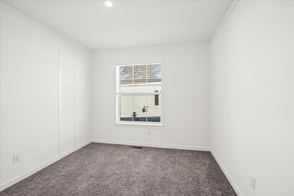 6 Berry Farms Road, Unit 64 Sturbridge, MA 01566 - Photo 16 of 18 an empty room with a window