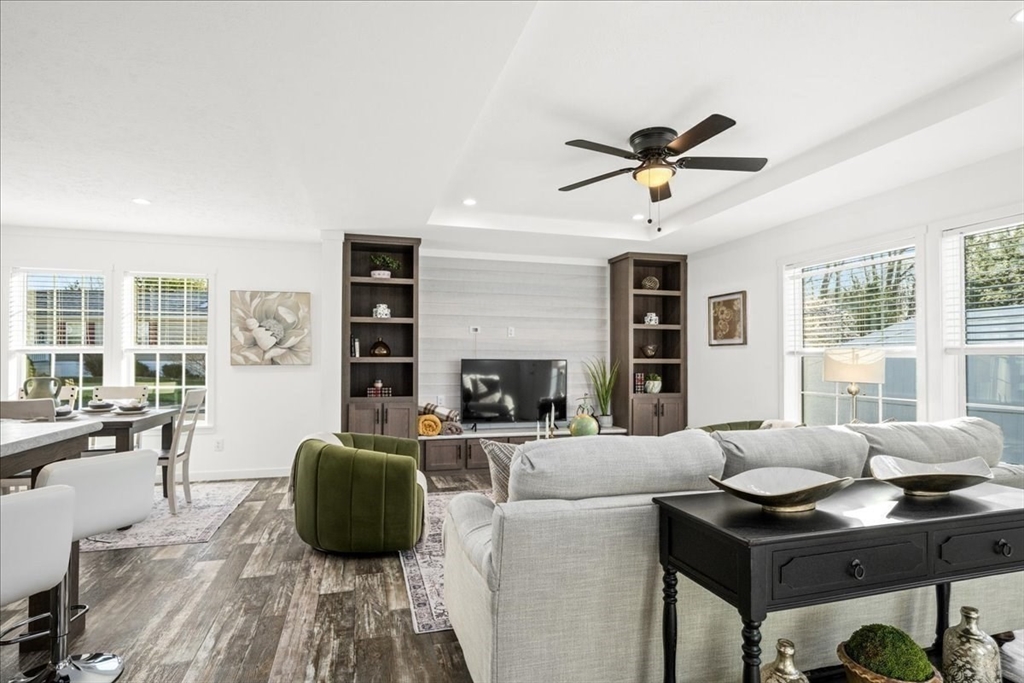 6 Berry Farms Road, Unit 64 Sturbridge, MA 01566 - Photo 5 of 18 a living room with furniture a fireplace and a chandelier