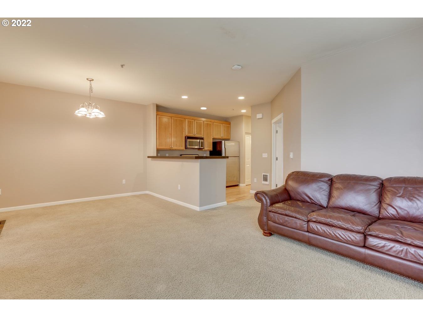 1020 Southwest 170th Avenue, Unit 100 Beaverton, OR 97003 - Photo 11 of 28 a living room with furniture and kitchen view