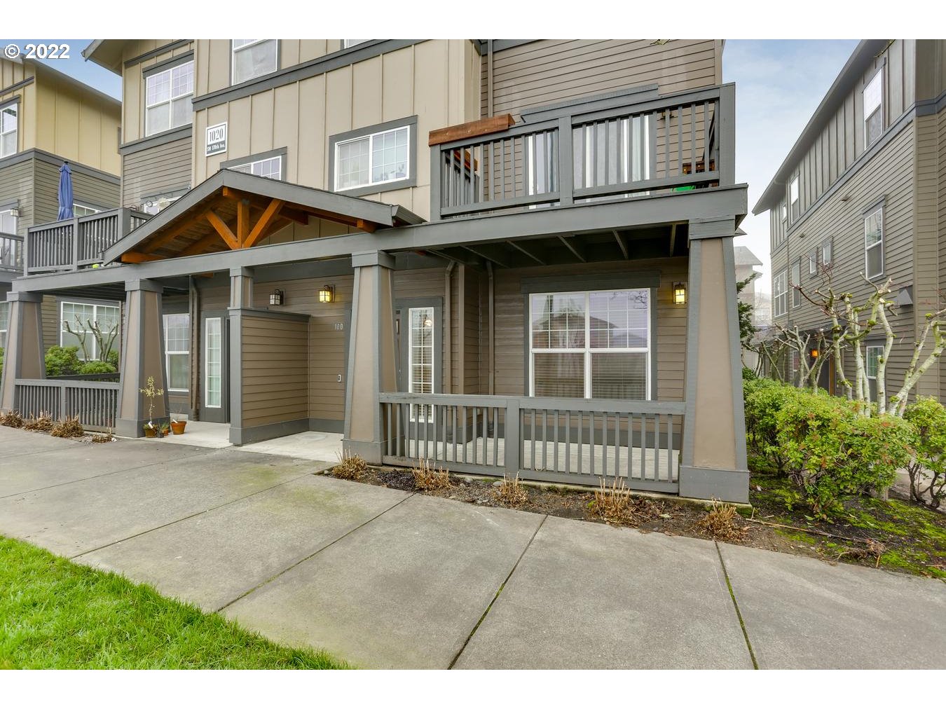 1020 Southwest 170th Avenue, Unit 100 Beaverton, OR 97003 - Photo 2 of 28 a view of a house with wooden fence