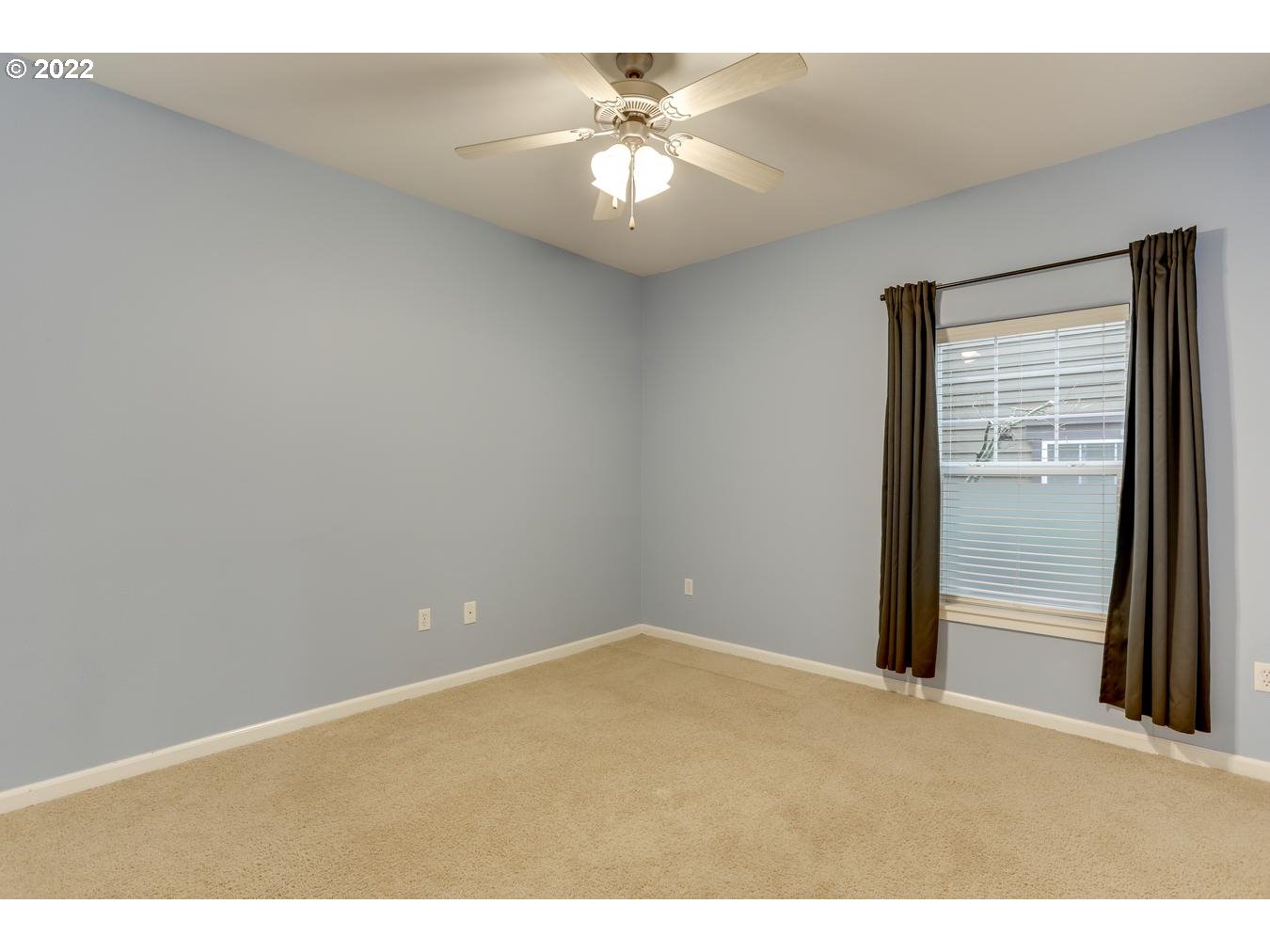 1020 Southwest 170th Avenue, Unit 100 Beaverton, OR 97003 - Photo 21 of 28 a view of a room with a ceiling fan and a window