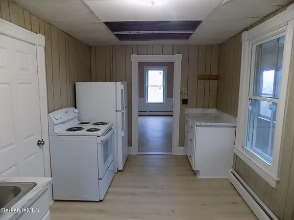 a view of a hallway with washer and dryer