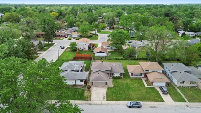 an aerial view of multiple houses with yard