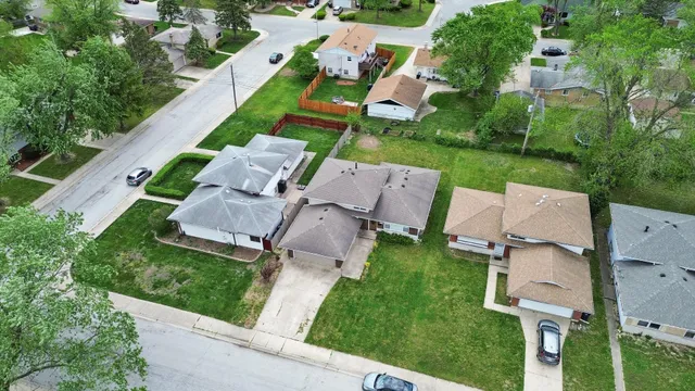 an aerial view of a house with garden space and street view
