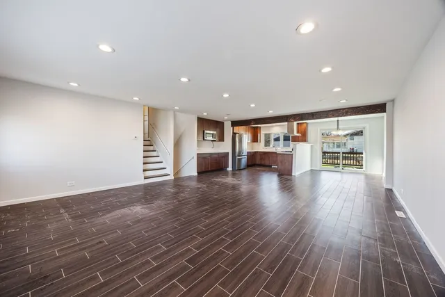 a view of kitchen with livingroom and wooden floor