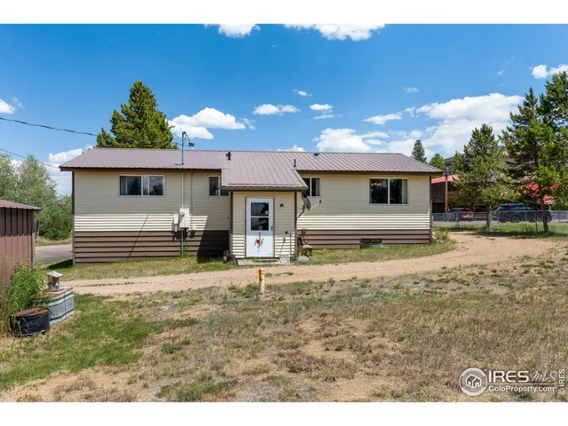 a aerial view of a house with a yard and balcony