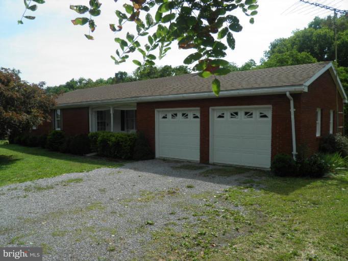 166 Bennett Berkeley Springs Berkeley Springs, WV 25411 - Photo 1 of 27 a house with a tree in front of it